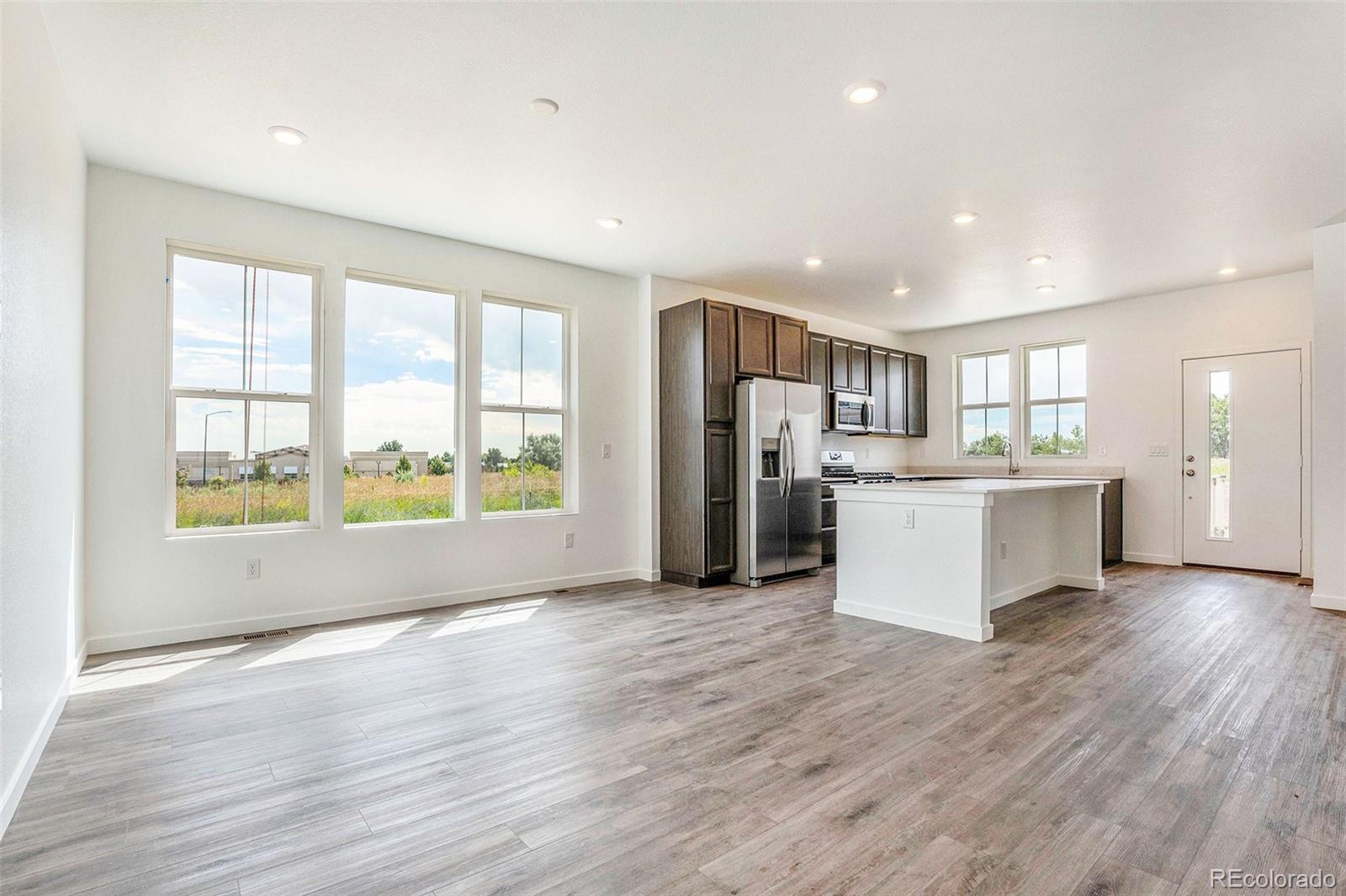 874 Furrow Way Lafayette, CO 80026 - Photo 6 of 27 a view of kitchen with refrigerator and wooden floor
