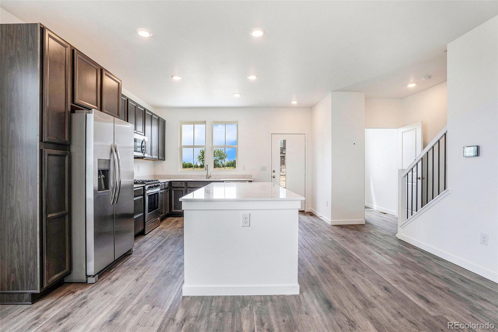 874 Furrow Way Lafayette, CO 80026 - Photo 7 of 27 a kitchen with a refrigerator a sink and a stove top oven