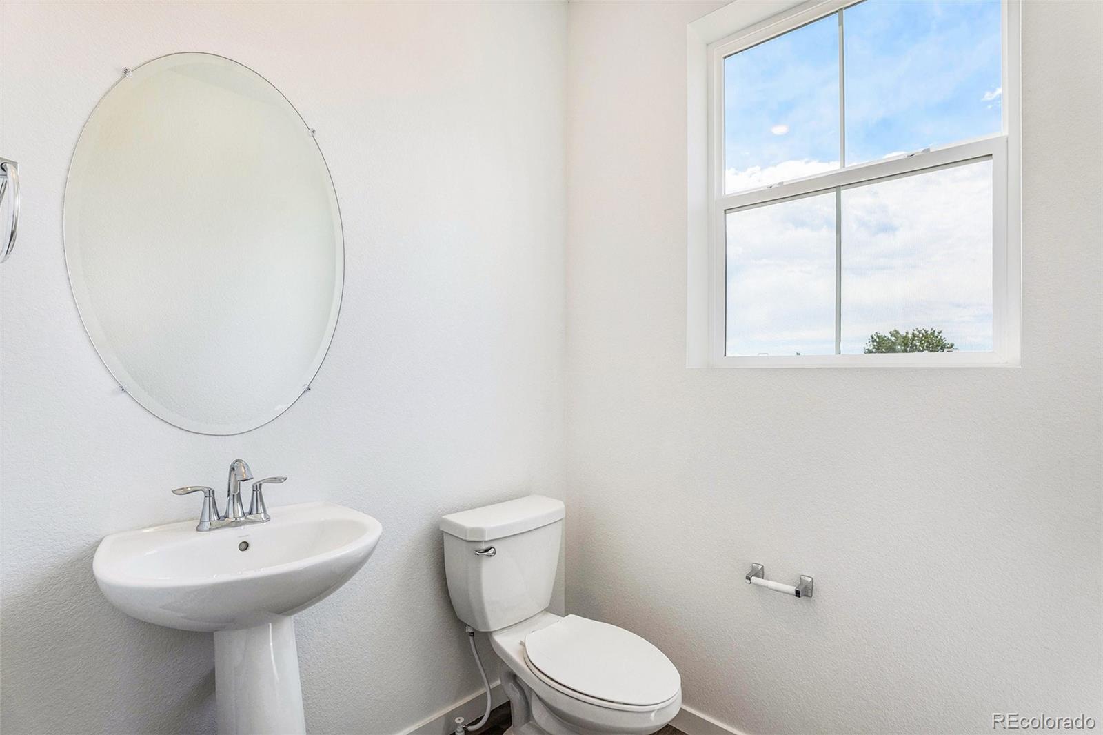 874 Furrow Way Lafayette, CO 80026 - Photo 10 of 27 a bathroom with a sink a mirror and a toilet