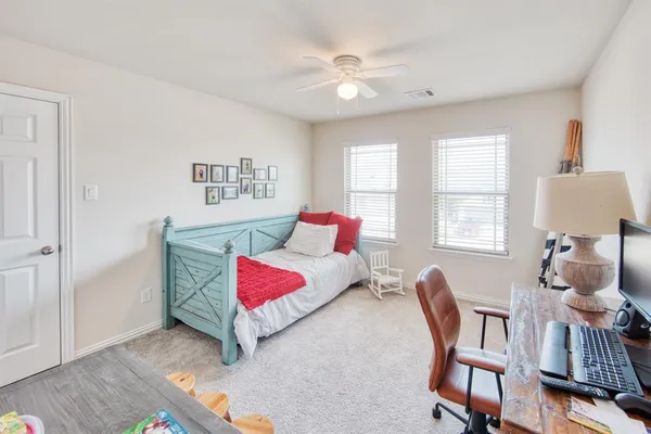 a bedroom with furniture and a window