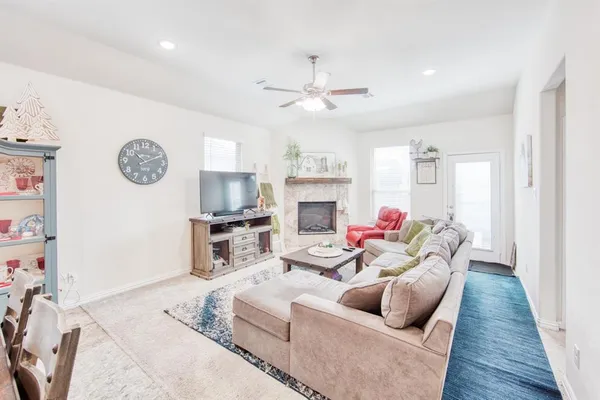 a living room with furniture and a fireplace