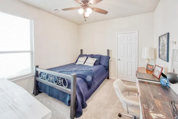 a bedroom with a bed and a chandelier