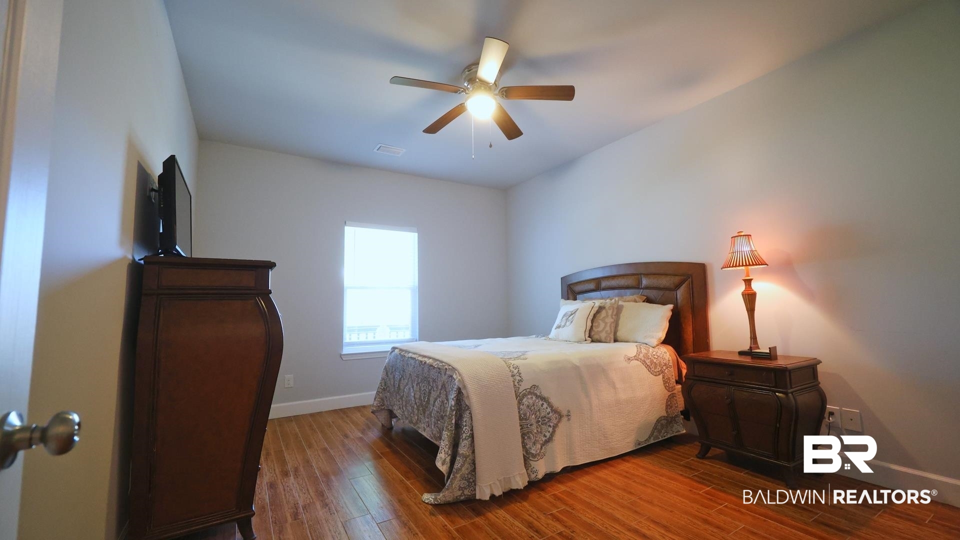 927 Periwinkle Lane Foley, AL 36535 - Photo 15 of 26 Vaulted ceiling room featuring wood-finish flooring, a window, and a ceiling fan with integrated lighting