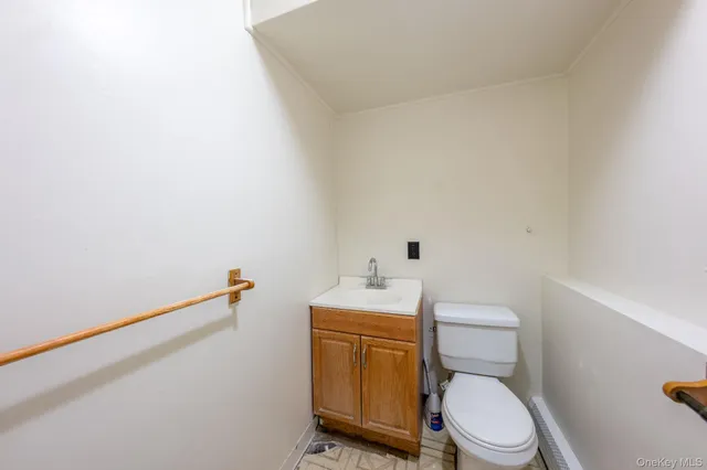 a white toilet sitting next to a bathroom sink