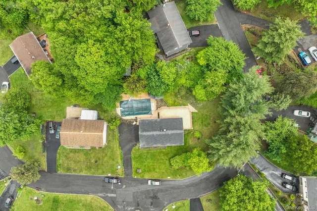 an aerial view of a house with a garden and trees