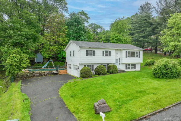 a view of a house with a yard porch and sitting area