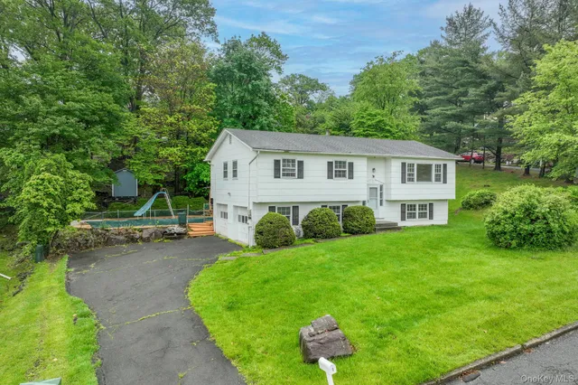 a view of a house with a yard porch and sitting area