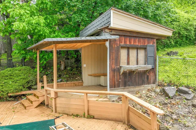 a view of a house with backyard and porch