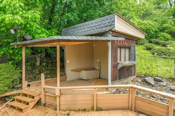 a backyard of a house with lake view and a potted plant