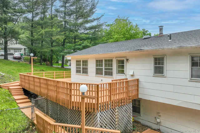 a view of a house with a wooden deck
