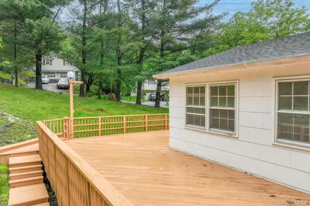 a view of a house with backyard and deck