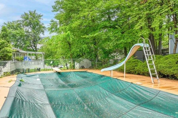 a view of a backyard with swimming pool