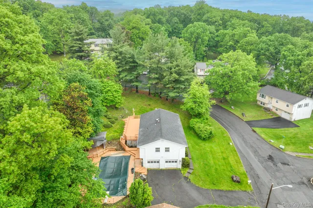 an aerial view of a house with outdoor space and street view