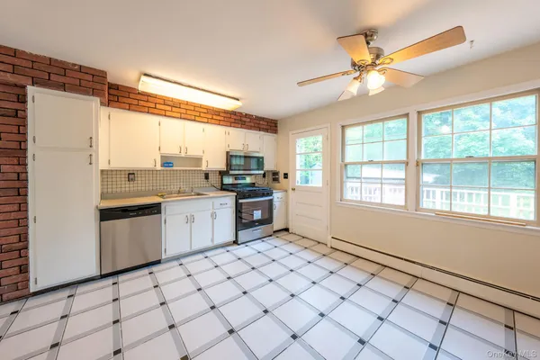 a kitchen with a stove a sink and a refrigerator