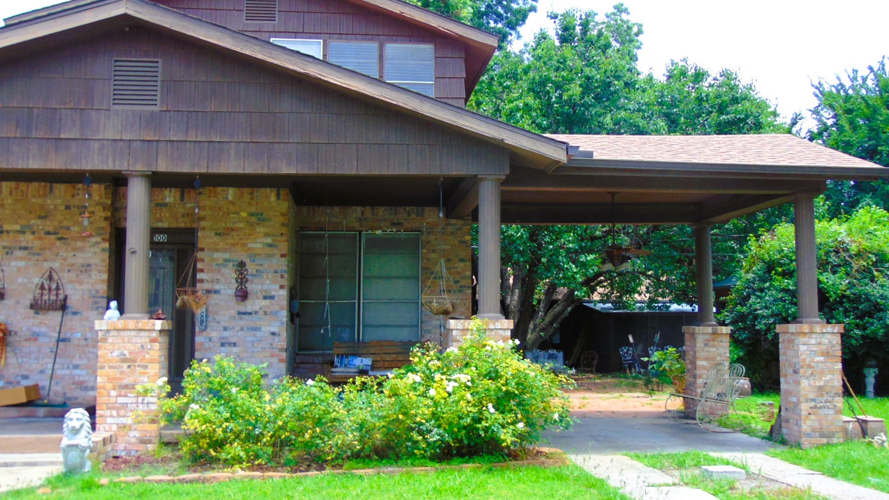 100 West Caroline Street Trinity, TX 75862 - Photo 1 of 28 a backyard of a house with a fountain swing table and chairs