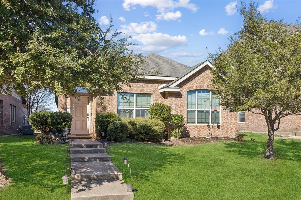 a front view of house with yard and green space