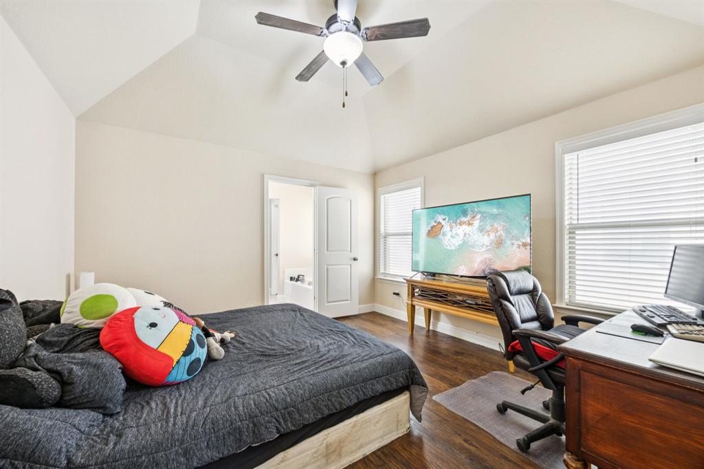 1601 Applegate Way Royse City, TX 75189 - Photo 11 of 28 a bedroom with a bed and a chandelier