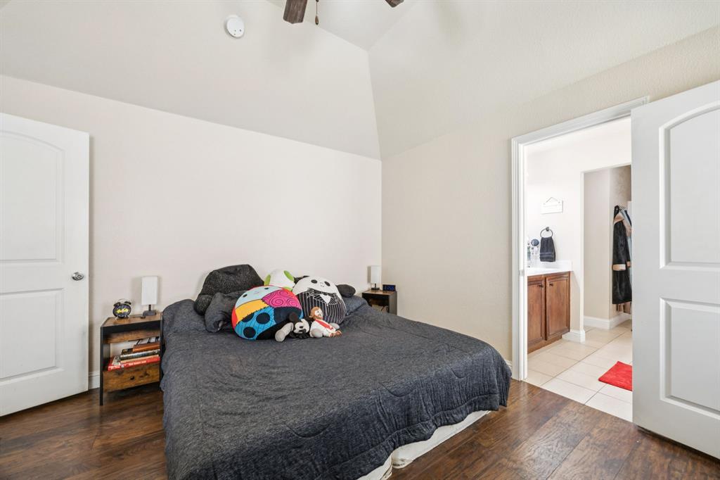 1601 Applegate Way Royse City, TX 75189 - Photo 13 of 28 a bedroom with a bed and wooden floor