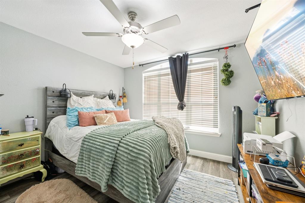 1601 Applegate Way Royse City, TX 75189 - Photo 18 of 28 a bedroom with a bed and a chandelier