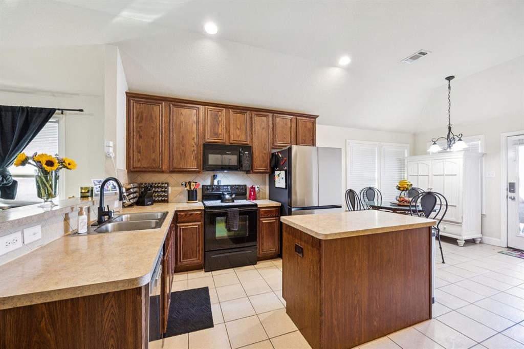 1601 Applegate Way Royse City, TX 75189 - Photo 7 of 28 a kitchen with kitchen island granite countertop a sink counter top space appliances and cabinets