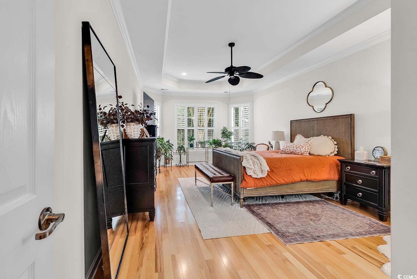 9 Saltwind Loop Murrells Inlet, SC 29576 - Photo 16 of 38 Bedroom featuring a raised ceiling, light wood-style floors, ornamental molding, and a ceiling fan