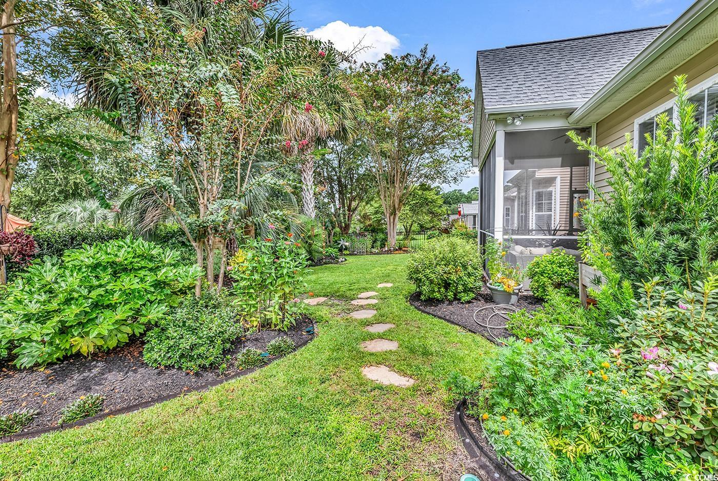 9 Saltwind Loop Murrells Inlet, SC 29576 - Photo 29 of 38 View of green lawn featuring a sunroom