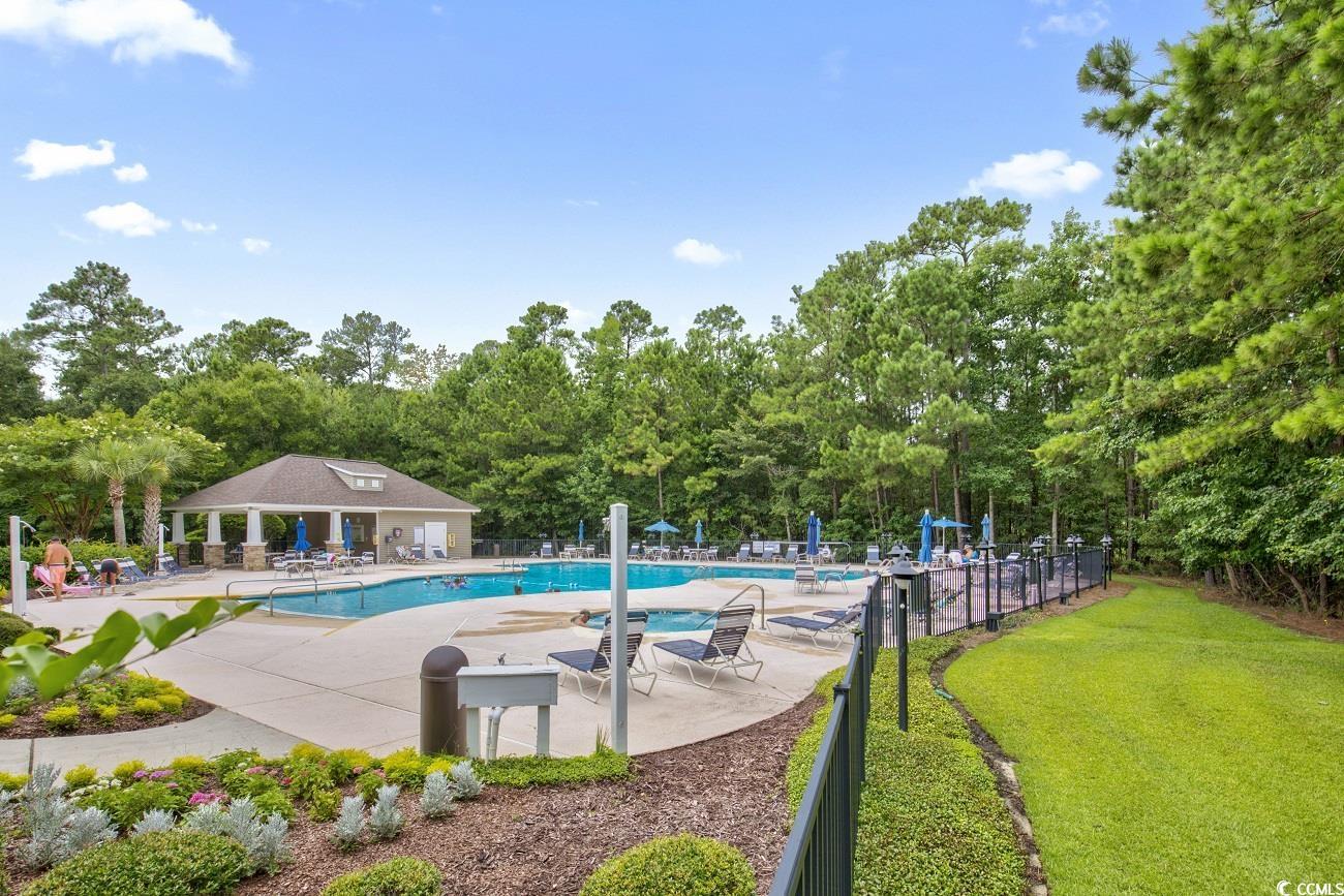 9 Saltwind Loop Murrells Inlet, SC 29576 - Photo 32 of 38 Community pool with a patio and view of wooded area