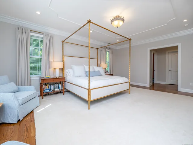 a spacious bedroom with a bed and a couch