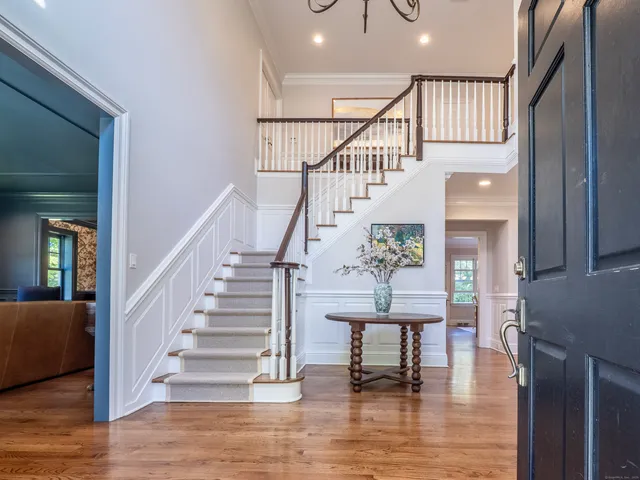 a view of entryway and hall with wooden floor