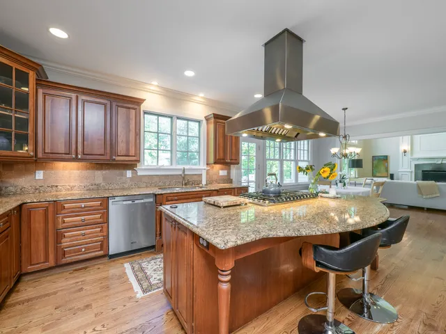 a kitchen with granite countertop a stove and cabinets