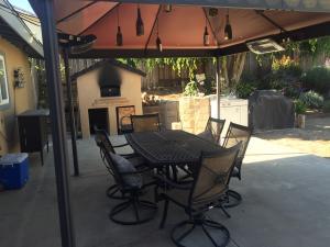 7020 Del Norte Drive Goleta, CA 93117 - Photo 2 of 8 a view of a patio with a table chairs and a small yard