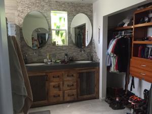 7020 Del Norte Drive Goleta, CA 93117 - Photo 7 of 8 a bathroom with a double vanity sink and a mirror