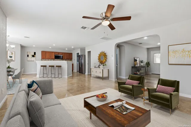 a living room with furniture and wooden floor