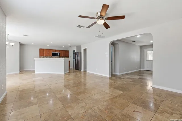 a view of a livingroom with a ceiling fan and entryway