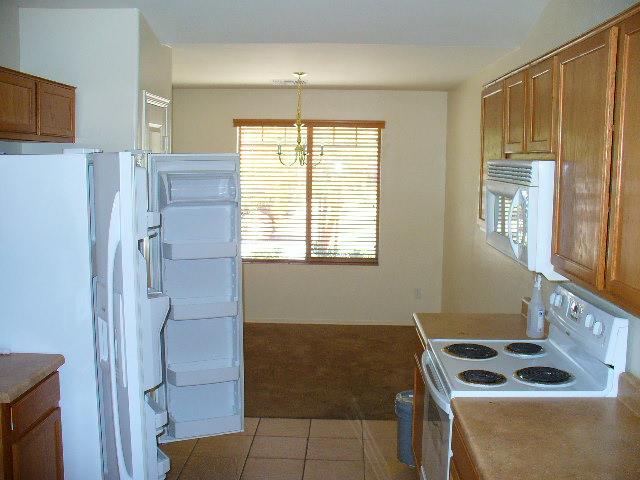 8629 West Payson Road Tolleson, AZ 85353 - Photo 5 of 13 DINING AREA TOWARD THE BACK OF THE KITCH