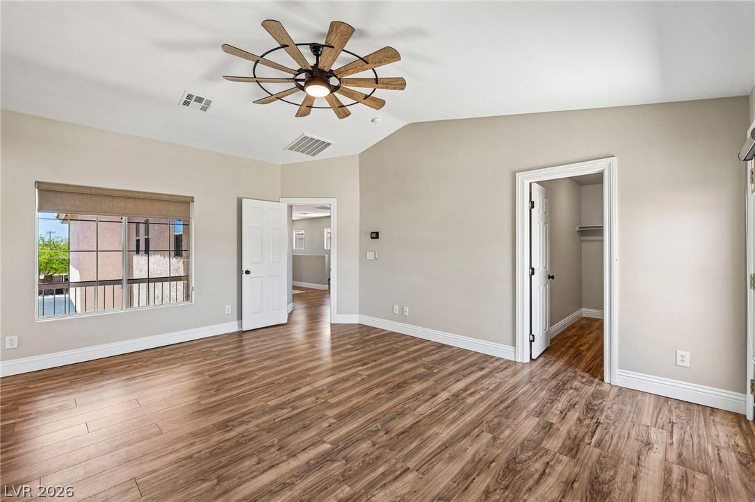 1176 Butternut Ranch Court Henderson, NV 89052 - Photo 32 of 60 An airy bedroom with wood flooring and a distinctive ceiling fan for comfort.