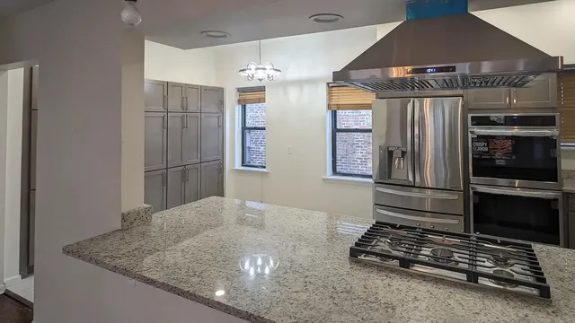 a view of a kitchen with wooden floor and a kitchen