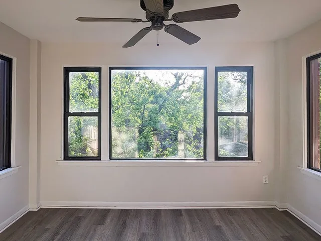 a view of room with window and a ceiling fan