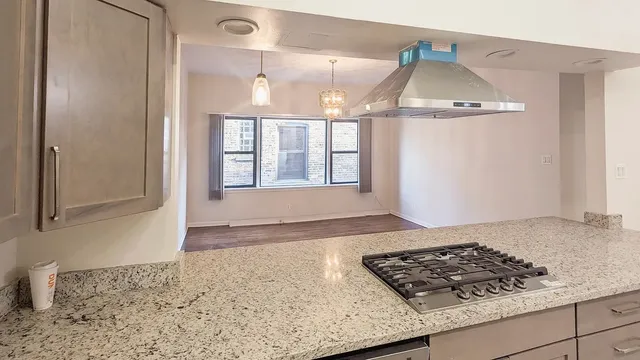 a kitchen with stainless steel appliances granite countertop a refrigerator and a sink