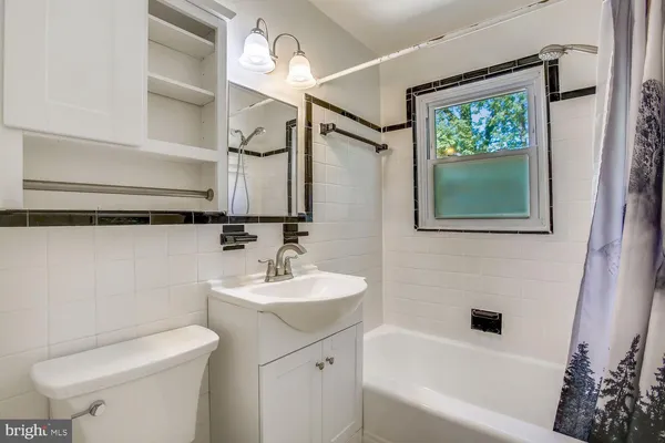 a bathroom with a sink a toilet and bathtub