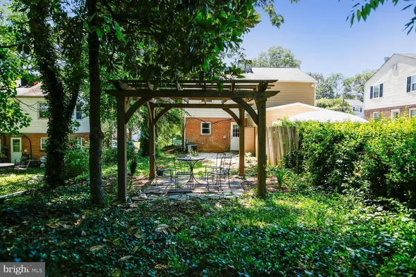 an aerial view of a house with garden space and street view