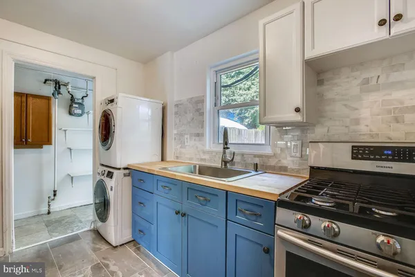 a kitchen with a sink stove and cabinets