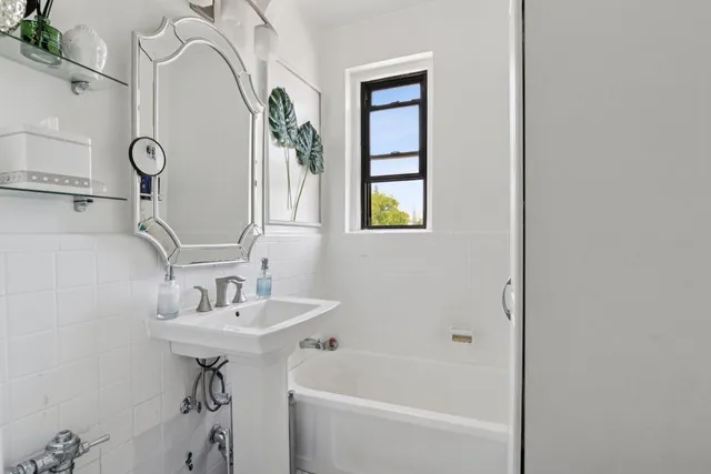 a bathroom with a sink a mirror and a bathtub
