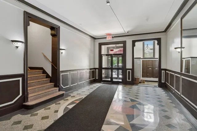 a view of a hallway with wooden floor and staircase