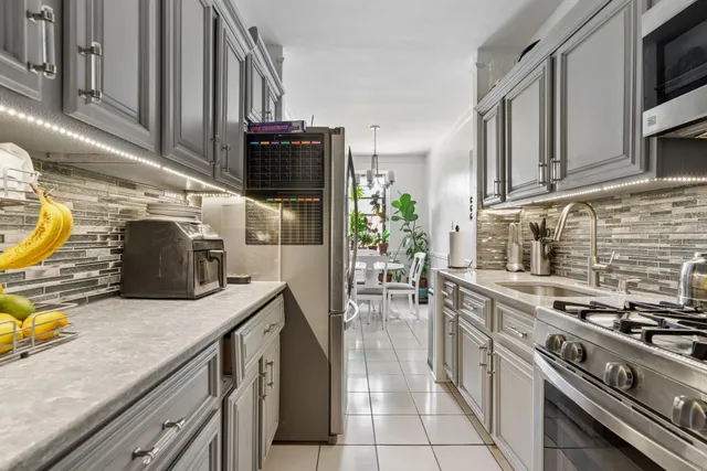 a kitchen with stainless steel appliances granite countertop a stove and a sink