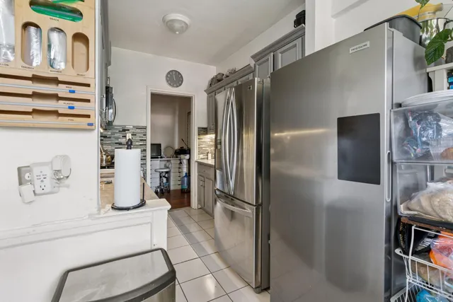 a kitchen with refrigerator and cabinets