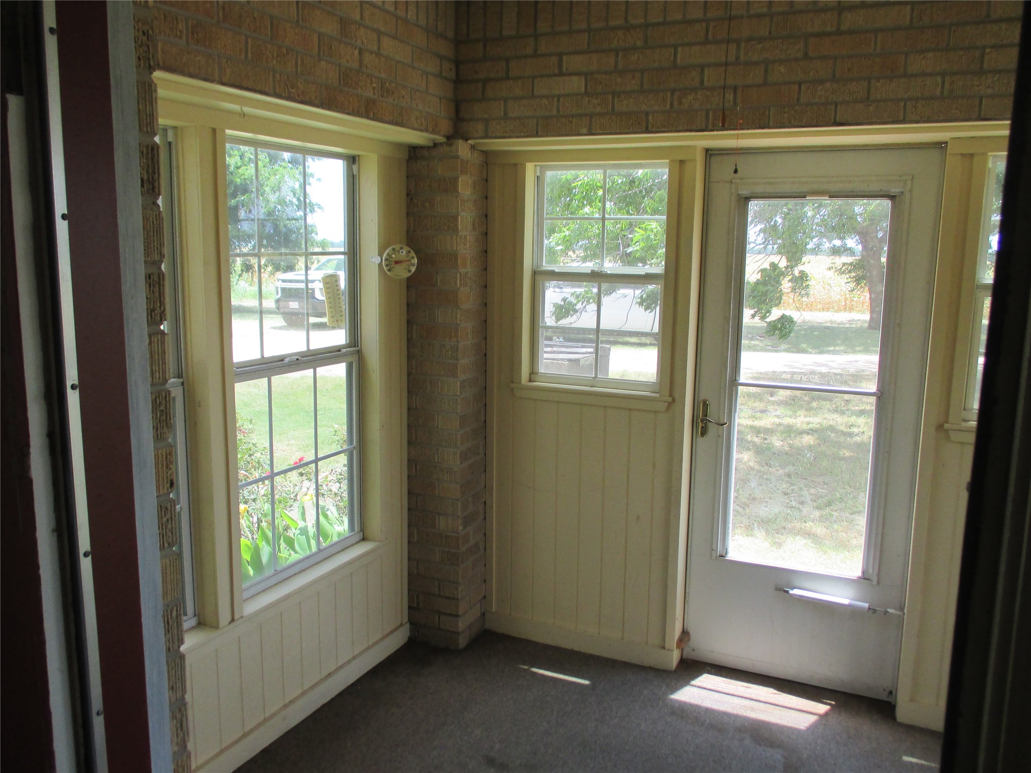 12610 Pecan School Road Bartlett, TX 76511 - Photo 16 of 21 A quaint enclosed porch offers serene views of the outdoors, providing a tranquil retreat.