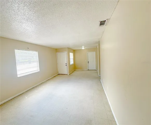 an empty room with a empty space and windows