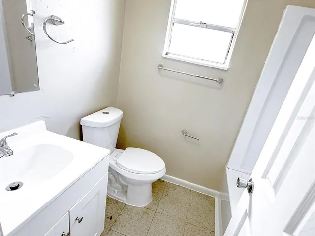 a white toilet sitting next to a bathroom sink