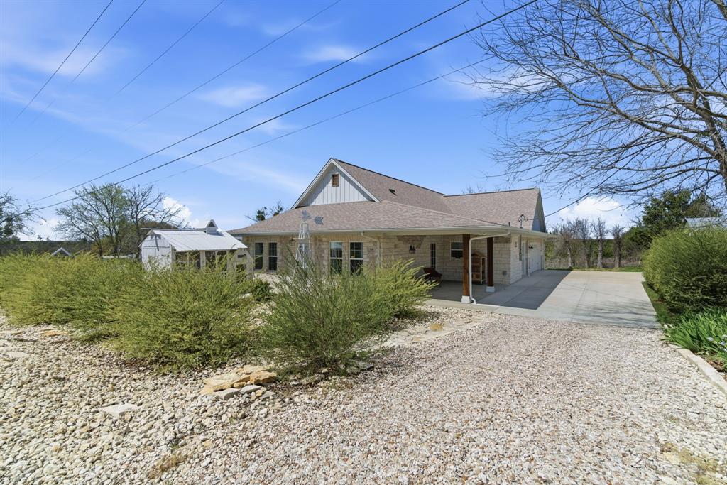 118 Heath Street Hico, TX 76457 - Photo 2 of 39 a front view of a house with garden